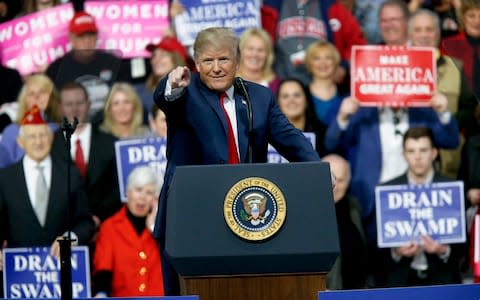 President Donald Trump reacts to the crowd while speaking at a campaign rally in Moon Township in Pennsylvania - Credit: AP