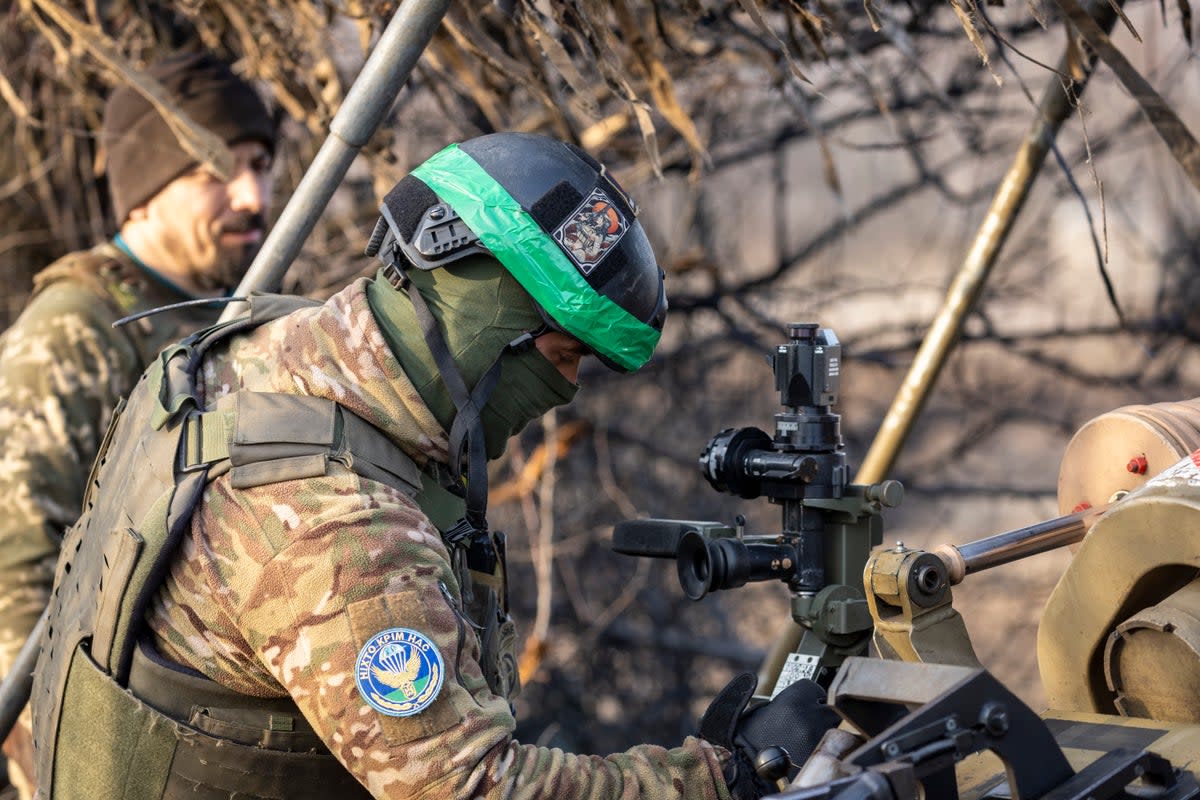 Soldiers from a Ukrainian assault brigade prepare to fire a British made L118 105mm Howitzer on Russian trenches near Bakhmut (Getty)