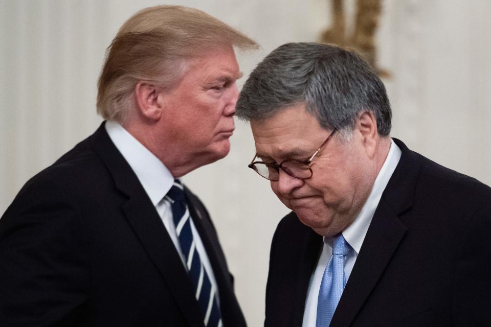 Donald Trump stands close to William Barr.