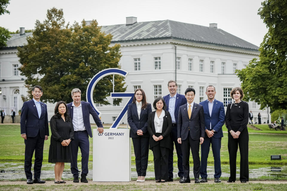 Robert Habeck, third left, Federal Minister for Economic Affairs and Climate Protection, receives Yulia Zvyrydenko, fourth left, Deputy Prime Minister and Minister of Economy of Ukraine, Yasutoshi Nishimura, third from right, Minister of Economy of Japan, Kenji Yamada, left, Minister of Foreign Affairs of Japan, Manlio Di Stefano, second from right, Undersecretary of State for Foreign Affairs of Italy, Mary Ng, second from left, Minister of Trade of Canada, Olivier Becht, fourth from right, Minister of Trade of France, Katherine Tai, right, Trade Representative of the United States, and Jo Crellin, right,, Minister of Trade of Canada.vl), Minister of Trade of Canada, Olivier Becht Minister of Trade of France, Katherine Tai, middle, Trade Representative of the United States, and Jo Crellin, right, Director General at the Department for International Trade of the United Kingdom, pose for a family photo at the beginning of the G7 Trade Ministers meeting at Neuhardenberg Castle on Wednesday, Sept. 14, 2022 in Neuhardenberg. (Kay Nietfeld/dpa via AP)