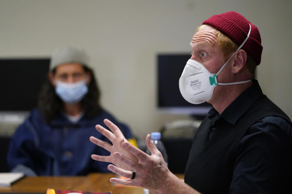 Instructor Douglas Arnwine speaks to his incarcerated students during a Mount Tamalpais College English class called Cosmopolitan Fictions at San Quentin State Prison April 12, 2022, in San Quentin, Calif. The community college, the first in California with a campus inside a prison, is the latest addition to San Quentin's numerous rehabilitation programs that have made it a desired destination for inmates throughout the state. (AP Photo/Eric Risberg)