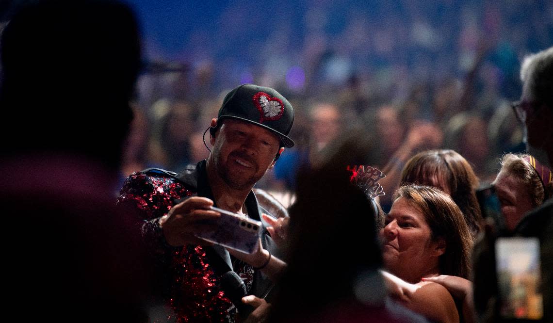 Donnie Wahlberg poses for a selfie with a fan on the “Mixtape 2022 Tour” at Raleigh, N.C.’s PNC Arena, Friday night, July 22, 2022.