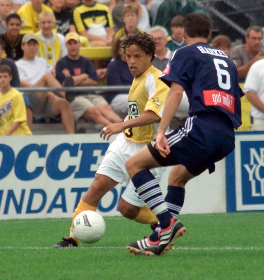 (7/29/00,twr,MLS, Columbus, Ohio) Cobi Jones left tries drive around #6 John Harkes of the East team at the MLS all-star game at Crew Stadium. Revell/Photo all names are (cq).