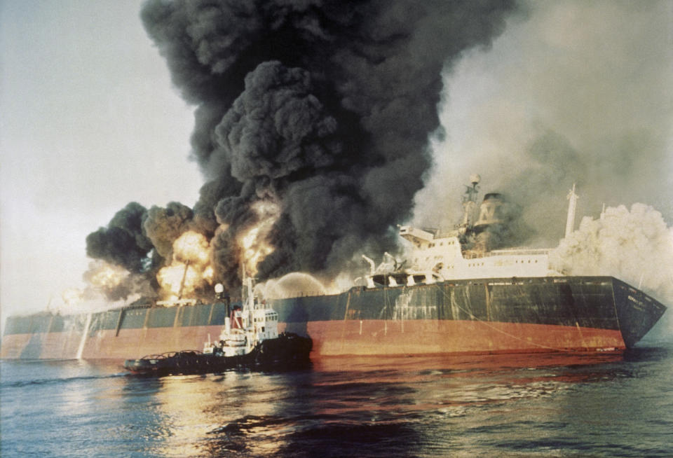 FILE - In this Dec. 6, 1987 file photo, the Singapore-registered tanker Norman Atlantic sits ablaze in the Strait of Hormuz after being attacked by an Iranian gunboat. The U.S. Navy is trying to put together a new coalition of nations to counter what it sees as a renewed maritime threat from Iran. Meanwhile, Iran finds itself backed into a corner and ready for a possible conflict. It stands poised on Friday, Sept. 6, 2019, to further break the terms of its 2015 nuclear deal with world powers. (AP Photo, File)