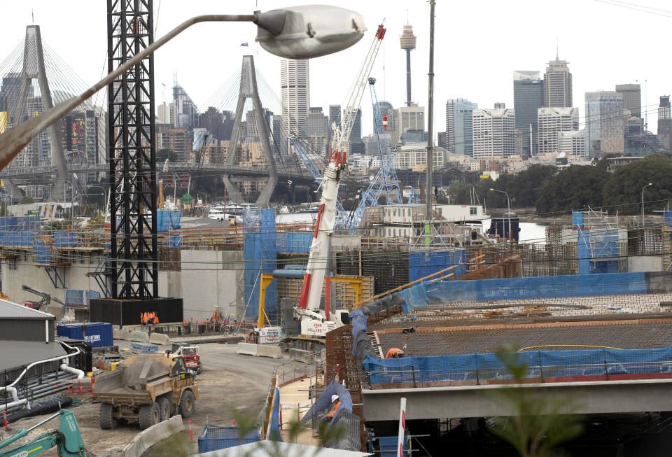 Construction teams work on a major road project in Sydney, Australia, Tuesday, May 11, 2021. The Australian government will release its big-spending economic plan for the next fiscal year on Tuesday designed to create jobs and repair pandemic damage and with an eye toward winning votes at looming general elections. (AP Photo/Mark Baker)