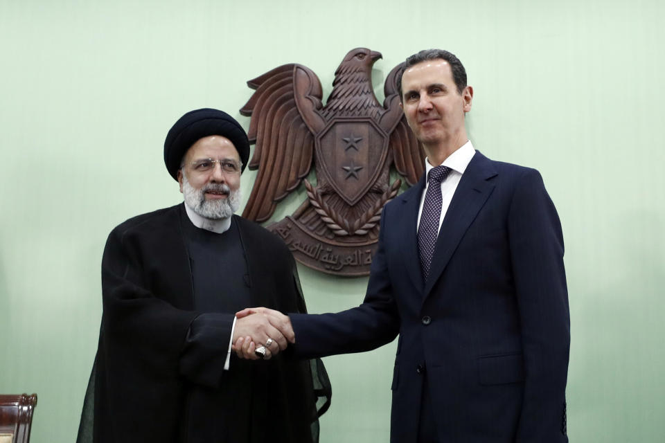 Syrian President Bashar Assad, right, shakes hands with Iranian President Ebrahim Raisi in Damascus, Syria, Wednesday, May 3, 2023. Raisi Wednesday met Assad in Damascus in a bid to boost cooperation between the two allies, state media reported. (AP Photo/Omar Sanadiki)