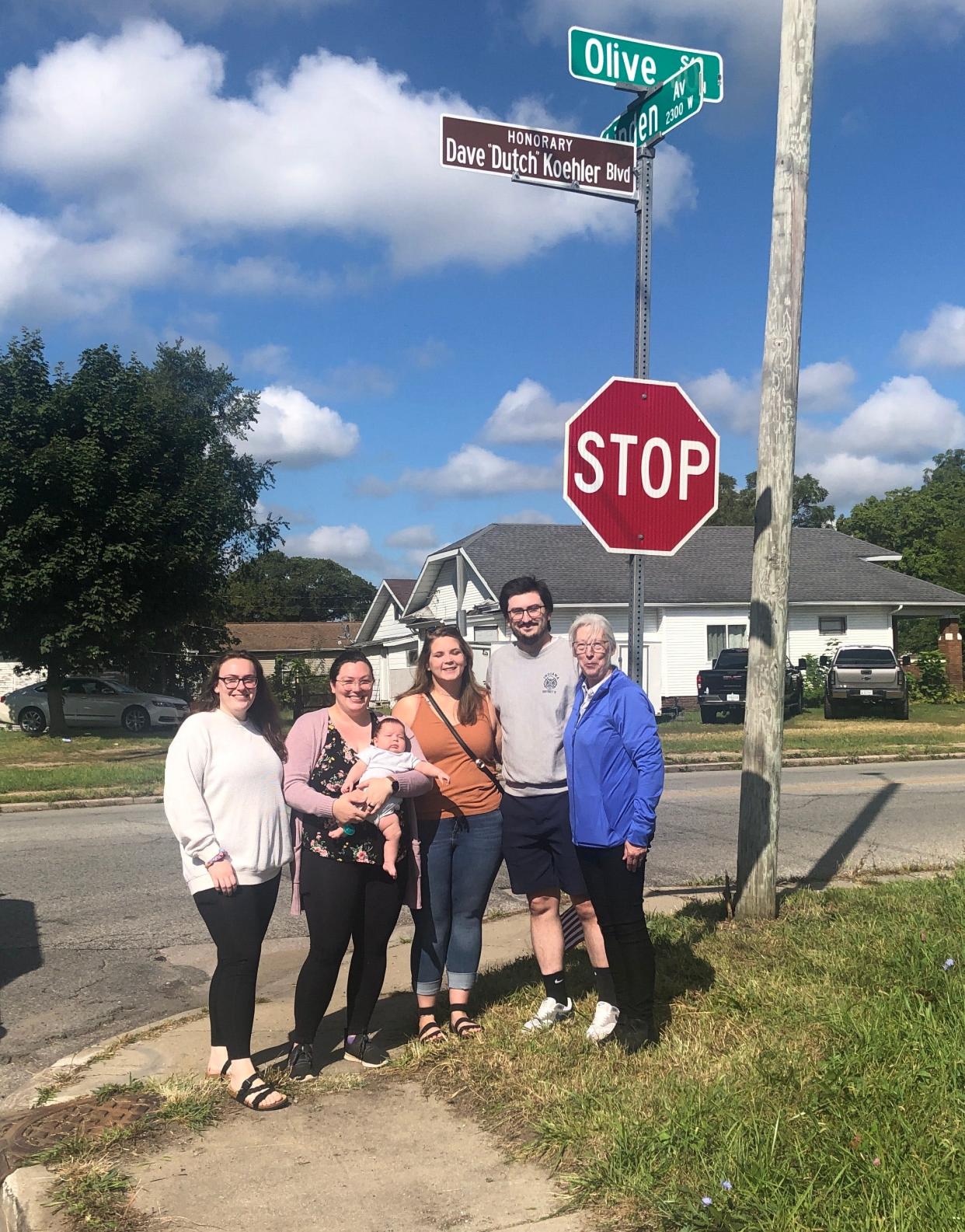 The Koehler family — Grace Lamb, left, Marissa Koehler, Sarah Berg, Brennon Koehler and Vicki Koehler — gathers at the unveiling of an honorary street sign named for Capt. Dave “Dutch” Koehler, a 32-year veteran of the South Bend Fire Department who died from brain cancer in August 2019. The sign is in the 200 block of North Olive Street, near the front of Station 4, his last duty assignment. Vicki was his wife, and Grace, Marissa and Brennon are his children.