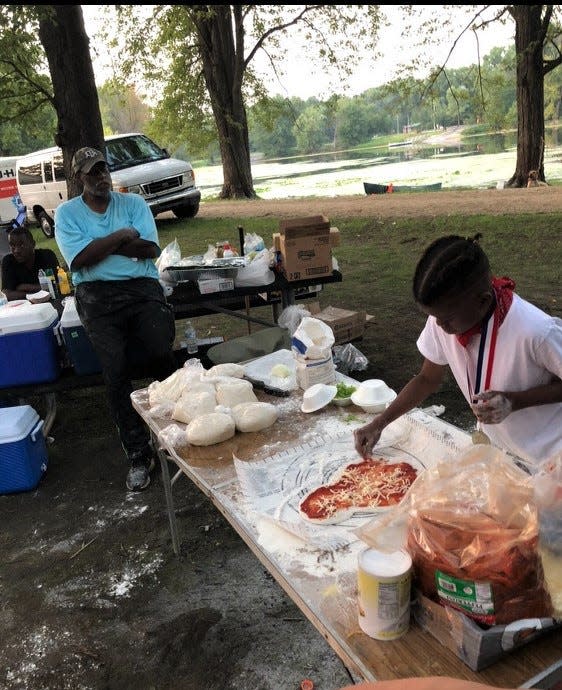 Roasting marshmallows by the fire is a tradition for any camping trip but, for youth attending the annual Camp "Xhongo" Peace Father and Son and Friends Retreat, so is making pizza.