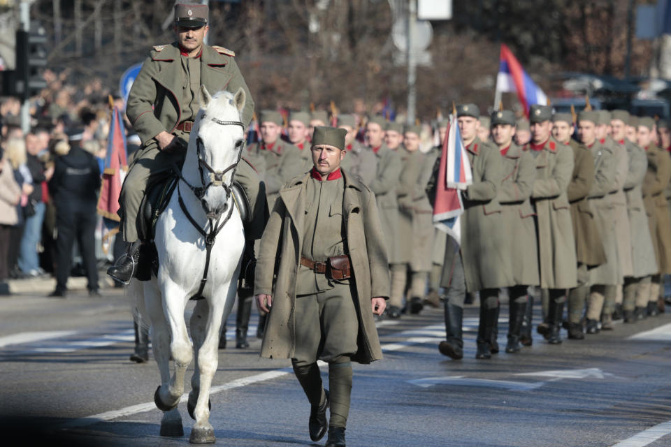 Members of the police forces of the Republic of Srpska dressed in military outfit from First World War march during a parade marking the 27th anniversary of the Republic of Srpska in the Bosnian town of Banja Luka, Wednesday, Jan. 9, 2019. In a show of nationalist defiance, Bosnian Serbs are celebrating a controversial holiday despite strong opposition from other ethnic groups in Bosnia who view it as discriminatory. Waving Serb flags, several thousand people on Wednesday lined up in the main Serb city of Banja Luka to watch a celebratory parade of security troops, firefighters, cultural and sport groups. (AP Photo/Amel Emric)