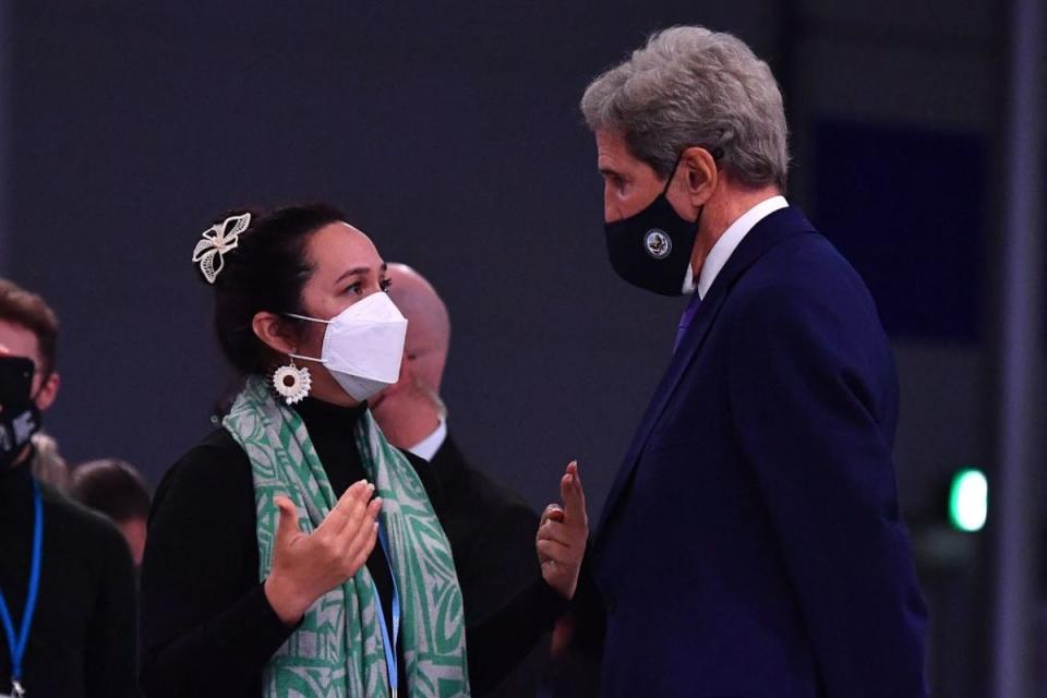 Climate Envoy for the Marshall Islands Tina Stege speaks with US special climate envoy, John Kerry, at Cop26 in Glasgow in 2021 (AFP via Getty Images)