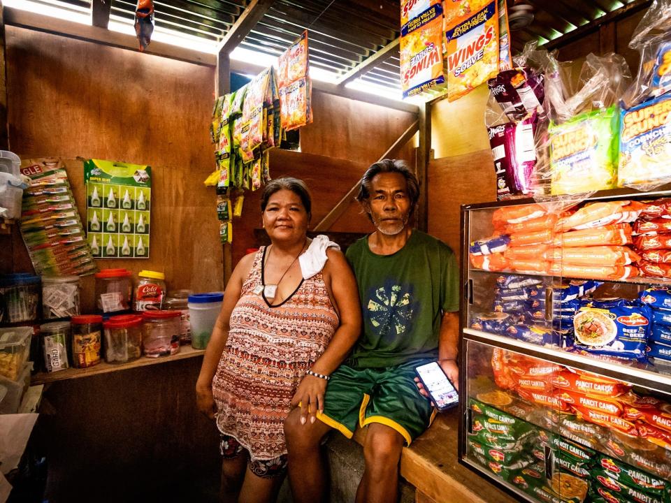 Gesophine with her husband inside their convenience store.