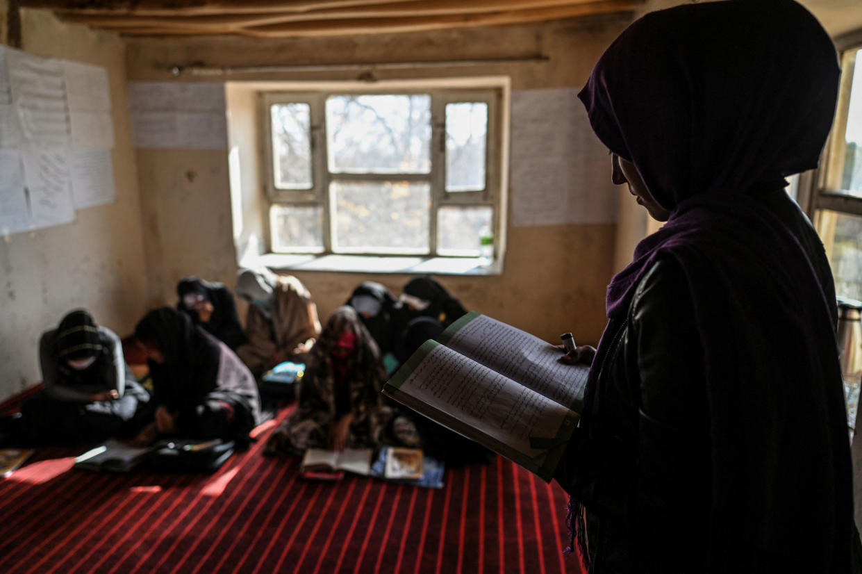 a teacher reading inside a class of grade 12 at a school in Langar village