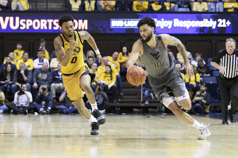 West Virginia guard Jermaine Haley (10) drives it up court as he is defended by Missouri guard Torrence Watson (0) during the second half of an NCAA college basketball game Saturday, Jan. 25, 2020, in Morgantown, W.Va. (AP Photo/Kathleen Batten)