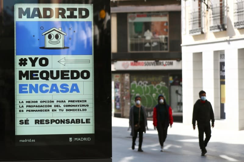 FILE PHOTO: FILE PHOTO: Ad advising people to be responsible and stay home is displayed in central Madrid