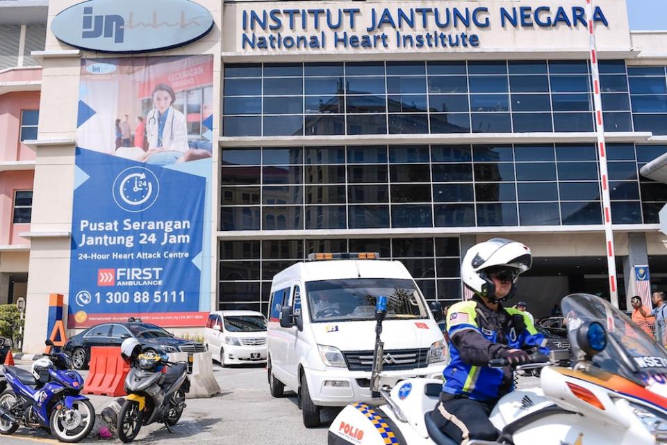 A hearse carrying Sultan Ahmad Shah’s body is escorted by police outriders as it leaves the National Heart Institute in Kuala Lumpur May 22, 2019. — Picture by Hari Anggara