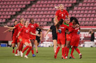 <p>KASHIMA, JAPAN - AUGUST 02: Gabrielle Carle #21, Nichelle Prince #15 and Adriana Leon #9 of Team Canada celebrate their side's victory with team mates after the Women's Semi-Final match between USA and Canada on day ten of the Tokyo Olympic Games at Kashima Stadium on August 02, 2021 in Kashima, Ibaraki, Japan. (Photo by Atsushi Tomura/Getty Images)</p> 