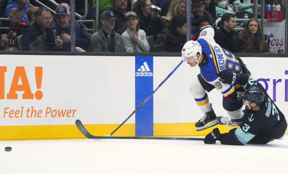 St. Louis Blues left wing Pavel Buchnevich (89) falls next to Seattle Kraken defenseman Will Borgen (3) during the second period of an NHL hockey game Friday, Jan. 26, 2024, in Seattle. (AP Photo/Lindsey Wasson)