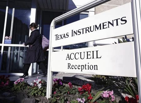 An employee enters the research building of Texas Instruments France firm in Villeneuve-Loubet near Nice December 18, 2012. REUTERS/Eric Gaillard