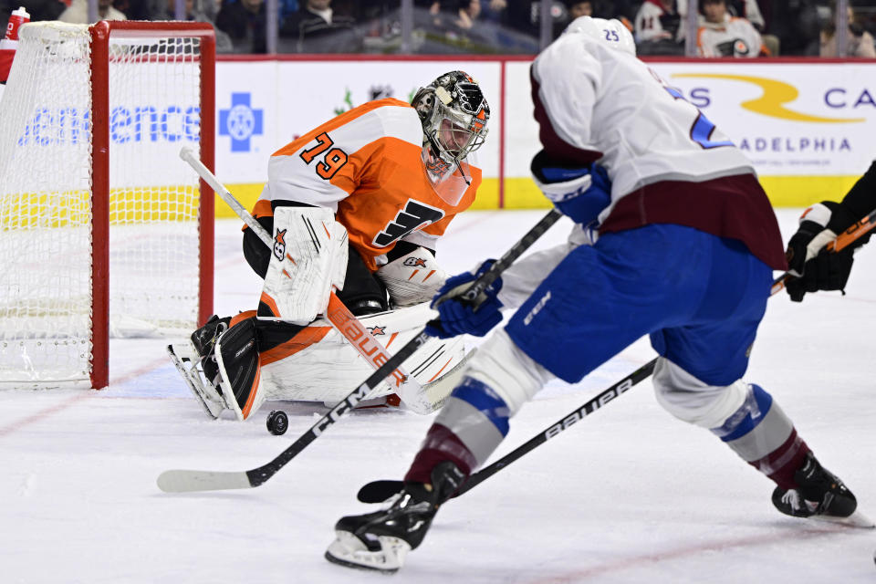 Philadelphia Flyers goaltender Carter Hart makes a save as Colorado Avalanche's Logan O'Connor closes in during the first period of an NHL hockey game, Monday, Dec. 5, 2022, in Philadelphia. (AP Photo/Derik Hamilton)