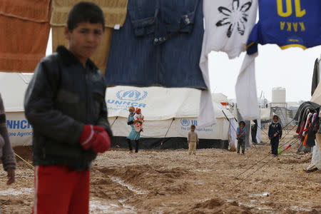 FILE PHOTO - A Syrian refugee boy walks near his family tent after the U.N. High Commissioner for Refugees (UNHCR) Antonio Guterres visited Al Zaatari refugee camp in the Jordanian city of Mafraq, near the border with Syria, January 15, 2015. REUTERS/Muhammad Hamed