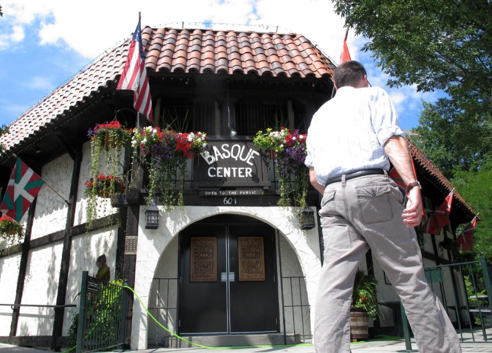 In this Aug. 7, 2013 photo, a man walks in front of the Basque Center in Boise, Idaho. The Basque Center is a gathering place for Boise's Basque community and one of several stops in the city's downtown Basque Block. The city’s Basque Block downtown is the best place for learning more about the heritage. As early the late 1800s, Basques began settling in southwestern Idaho, many lured here to work as sheepherders. The Basque Block includes a museum, a market, restaurants, street art and historical signage. (AP Photo/Todd Dvorak)