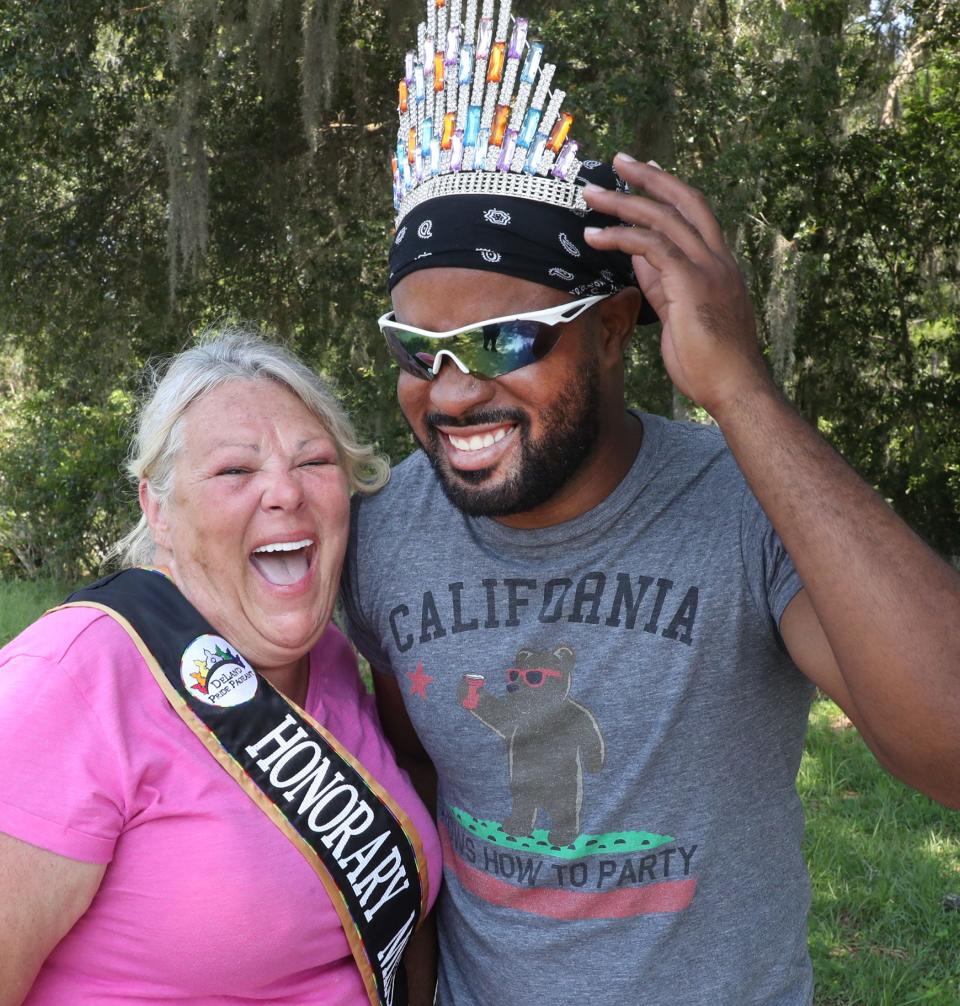 Mary Taylor Green, who was named Honorary Miss DeLand Pride at this year's pageant, lends her crown to and shares a laugh with Tony Bailey, her best friend who also helps Green on her farm in DeLand.