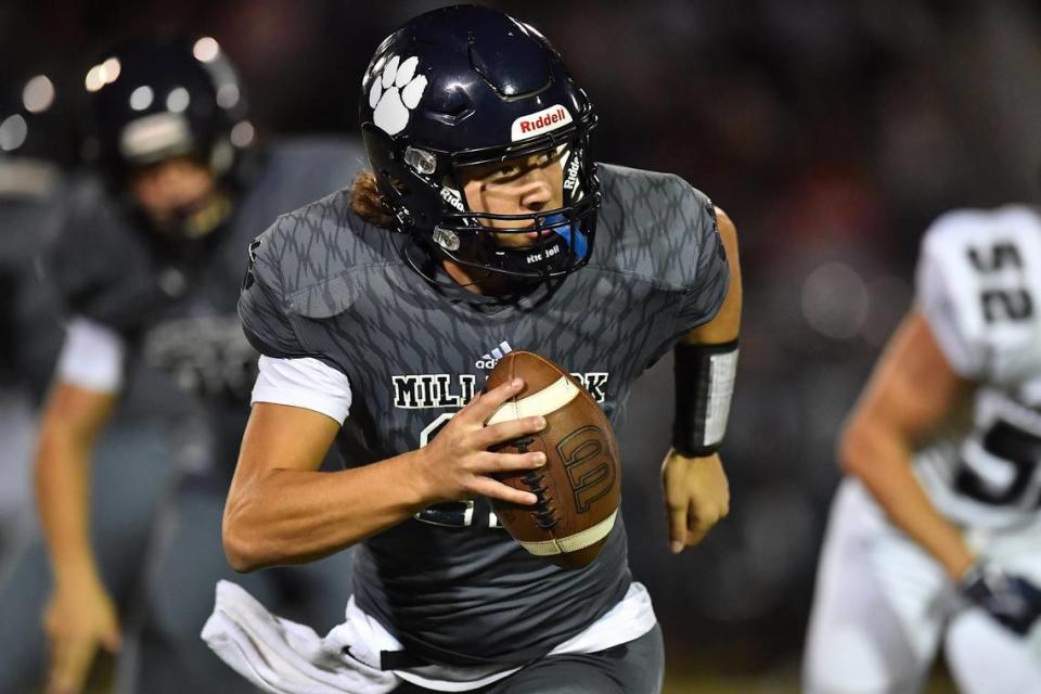 Millbrook quarterback Mason Fortune (11) runs and looks to pass against Heritage during the first half. The Millbrook Wildcats and the Heritage Huskies met in a football game in Raleigh, N.C. on September 29, 2022.