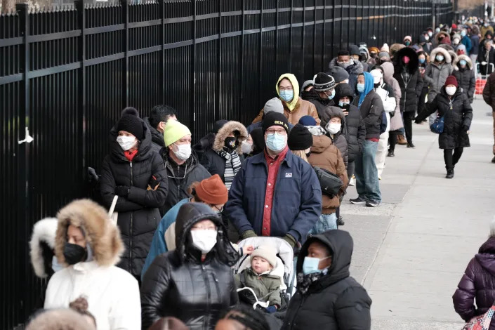 People wait in line as city workers hand out take-home Covid-19 test kits in lower Manhattan on December 23, 2021 in New York City. (Photo by Spencer Platt/Getty Images)