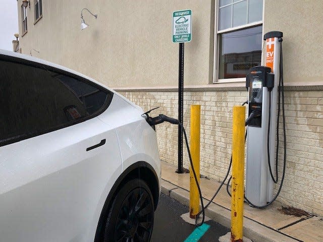 A Tesla charges up at an electric vehicle outlet on White Street in Red Bank.