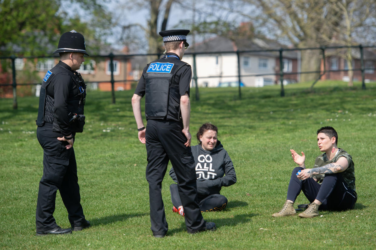 Police officers talk to members of the public at a park in Northampton, as Northants Police announce they are toughening up their social distancing enforcement, as the UK continues in lockdown to help curb the spread of Covid-19.