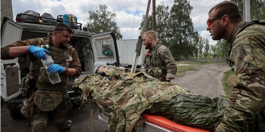 Military paramedics assist a wounded Ukrainian soldier near Vovchansk, Kharkiv Oblast, Ukraine, May 12, 2024
