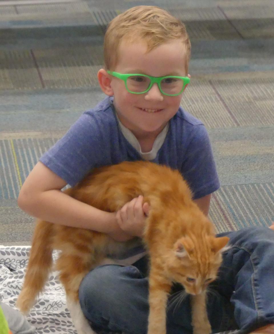 Brody Doughty was excited to hold an orange cat brought to the library by Cat Roundup Rescue on Sept. 26, 2023.