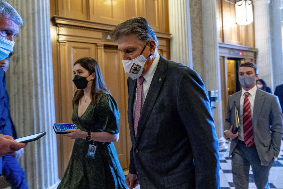 Sen. Joe Manchin, D-W.Va., a key holdout vote on President Joe Biden's domestic agenda, walks into the Senate Chamber at the Capitol in Washington, Tuesday, Oct. 19, 2021. (AP Photo/Andrew Harnik)