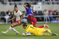 Canada's Kailen Sheridan, bottom, makes a save against United States' Jaedyn Shaw as Canada's Jade Rose defends during the first half of a SheBelieves Cup soccer match Tuesday, April 9, 2024, in Columbus, Ohio. (AP Photo/Jay LaPrete)
