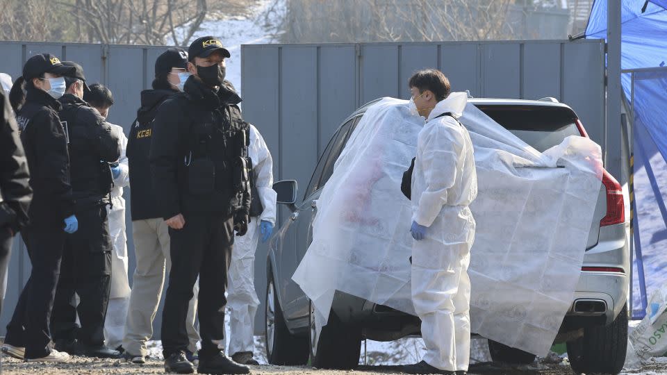 Members of the Korea Crime Scene Investigation investigate the car in which Lee was found unconscious in Seoul, December 27, 2023. - Seo Dae-youn/Yonhap/AP