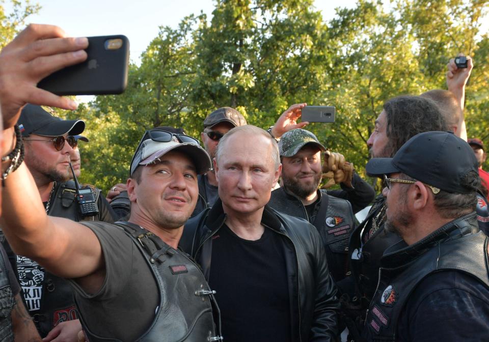 Russian President Vladimir Putin poses for a selfie with bikers during the Babylon's Shadow bike show camp near in Sevastopol, Crimea, Saturday, Aug. 10, 2019. (Alexei Druzhinin, Sputnik, Kremlin Pool Photo via AP)