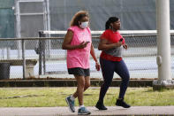 Walkers and runners take advantage of the 1-mile Parham Bridges walking track, Monday, March 23, 2020, in Jackson, Miss. Runners across the country are still hitting the pavement and the trails, staying fit and working off some stress amid the coronavirus pandemic. (AP Photo/Rogelio V. Solis)