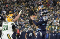 Tennessee Titans quarterback Ryan Tannehill (17) throws a pass under pressure from Green Bay Packers linebacker Preston Smith (91) during the second half of an NFL football game Thursday, Nov. 17, 2022, in Green Bay, Wis. (AP Photo/Morry Gash)