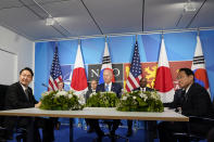 President Joe Biden, center, meets with South Korea's President Yoon Suk Yeol, left, and Japan's Prime Minister Fumio Kishida, right, during the NATO summit in Madrid, Wednesday, June 29, 2022. Seated behind Biden is, from left, White House national security adviser Jake Sullivan, Secretary of State Antony Blinken, Secretary of Defense Lloyd Austin. (AP Photo/Susan Walsh)