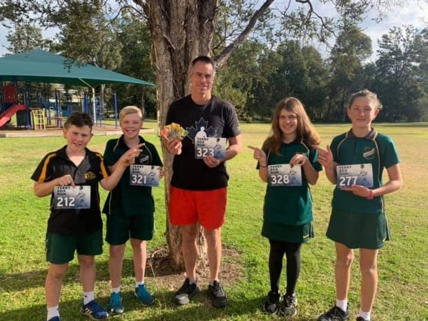 Matthew Reid, centre, was inspired by Terry Fox's story to raise money for children's charities in Australia. (submitted by Matthew Reid - image credit)