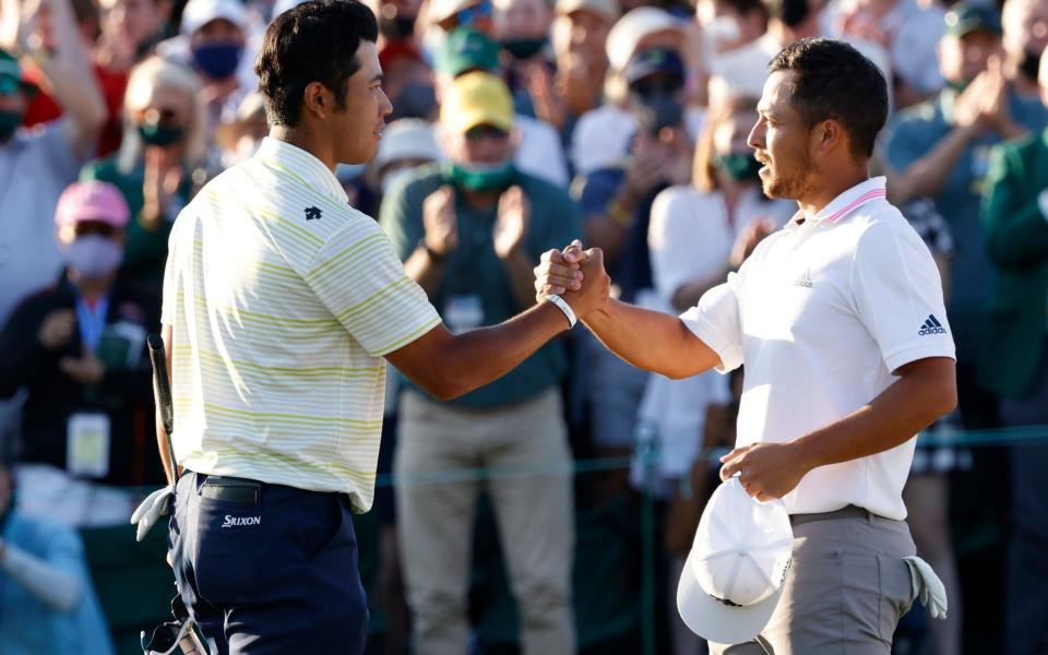 Japan's Hideki Matsuyama shakes hands with Xander Schauffele of the U.S. on the 18th green after winning The Masters  - Reuters