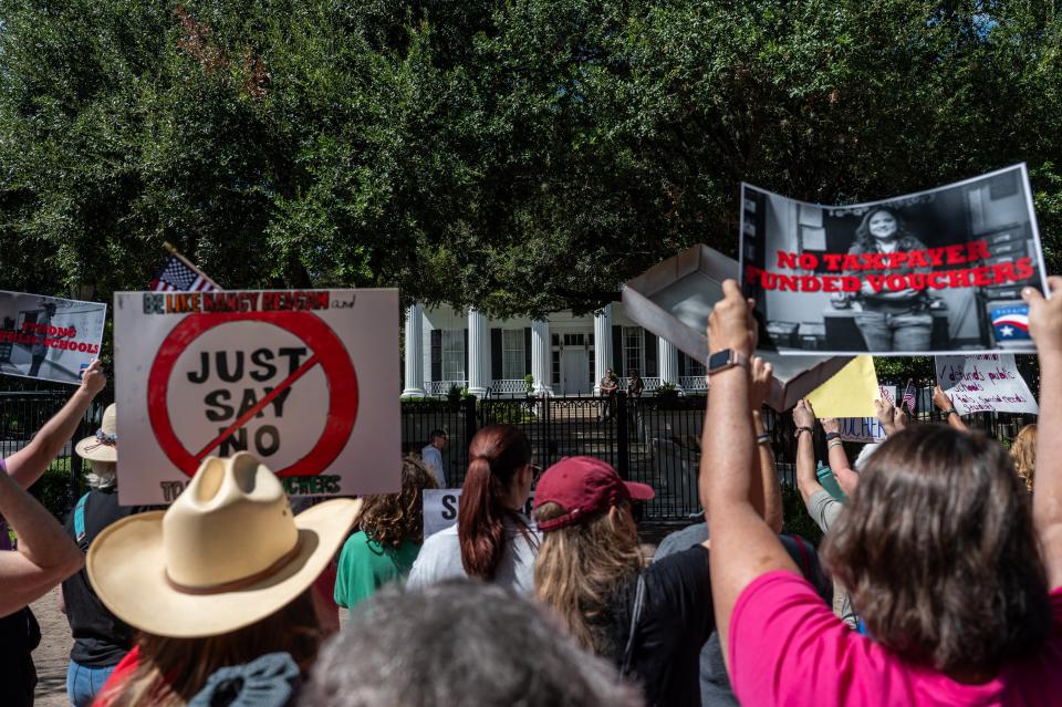 Protesters chant outside the Governor's Mansion last month in opposition to Gov. Greg Abbott's push for school choice programs to use state money to help pay for private school tuition.