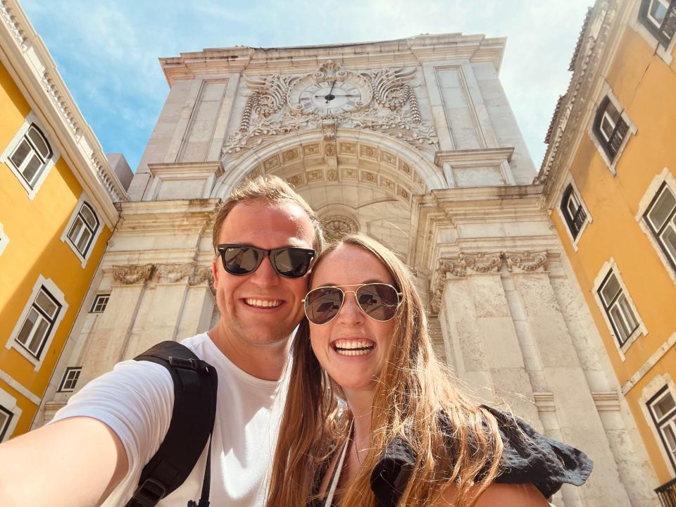 woman and man in front of clock monument