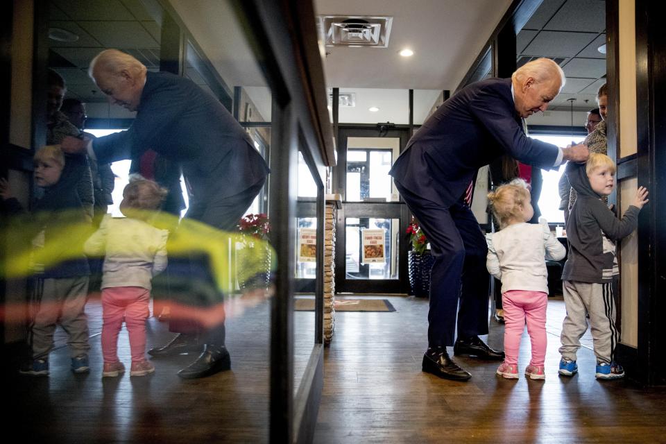 FILE - In this Jan. 6, 2020, file photo Democratic presidential candidate former Vice President Joe Biden speaks with Jack Maiers, 4, and his sister Olive, 2, of Bettendorf, Iowa, as he arrives for lunch at Ross' Restaurant in Bettendorf, Iowa. Biden has won the last few delegates he needed to clinch the Democratic nomination for president. (AP Photo/Andrew Harnik, File)