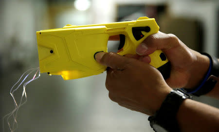 Montgomery County, Maryland police officer and instructor Craig Dickerson demonstrates an X2 taser during a demonstration for Reuters at the department's training academy in Rockville, Maryland, U.S. September 7, 2016. REUTERS/Gary Cameron/Files