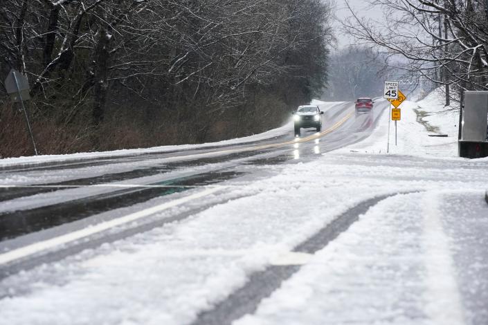 Motorists make their way through rain and snow along Highway 100 in Bellevue Sunday morning.