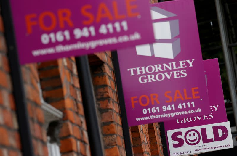 FILE PHOTO: Real estate agents boards are seen outside a row of terraced houses following the outbreak of the coronavirus disease (COVID-19), in Manchester