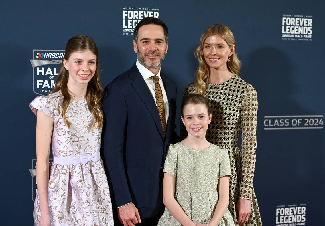 NASCAR Hall of Fame member Jimmie Johnson, center, poses with his wife Chandra Janway, right, and daughters Genevieve, left, and Lydia, right, on the red carpet at the NASCAR Hall of Fame in Charlotte, NC, on Friday, January 19, 2024.