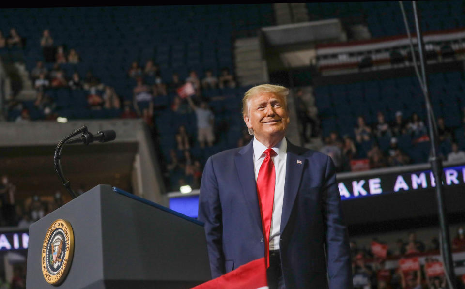 U.S. President Donald Trump smiles at the crowd as he arrives at the podium to speak during his first re-election campaign rally in several months in the midst of the coronavirus disease (COVID-19) outbreak, at the BOK Center in Tulsa, Oklahoma, U.S., June 20, 2020. REUTERS/Leah Millis