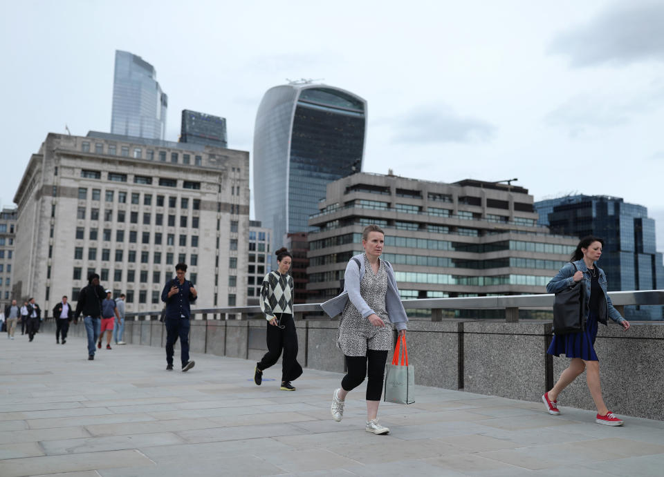 Commuters crossing London Bridge during evening rush hour. Train services have been ramped up from Monday in England and Wales reopen and workers are encouraged to return to offices.